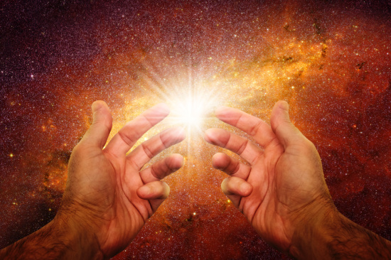 law of attraction visualization symbolized by light between two fingers.