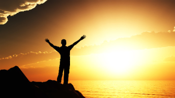 Self forgiveness allows you to be at peace and empowered.  This photo symbolizes that state of being where a man is uplifting his arms as he faces the sun on the beach.