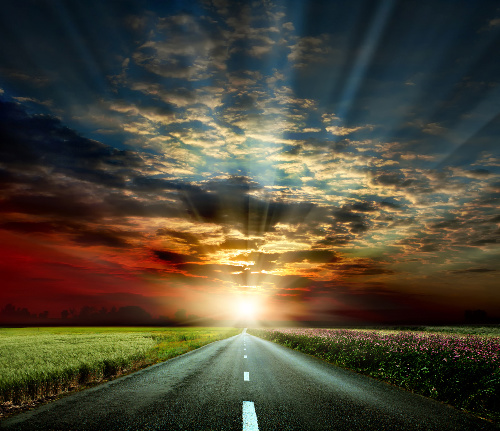 Road into the sunset symbolizing the journey of vibrational energy healing.