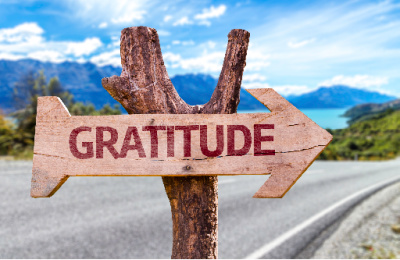 Create gratitude lists as a way to find direction.  Gratitude written out on an arrow pointing the way on the road.