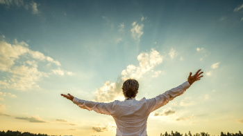 Prosperity Consciousness symbolized by man greeting the sun.