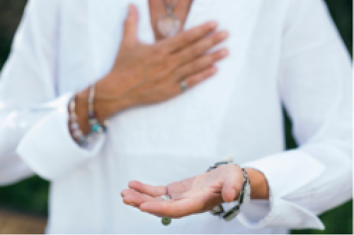 Woman practicing the facilitation of one form of spiritual energy healing.